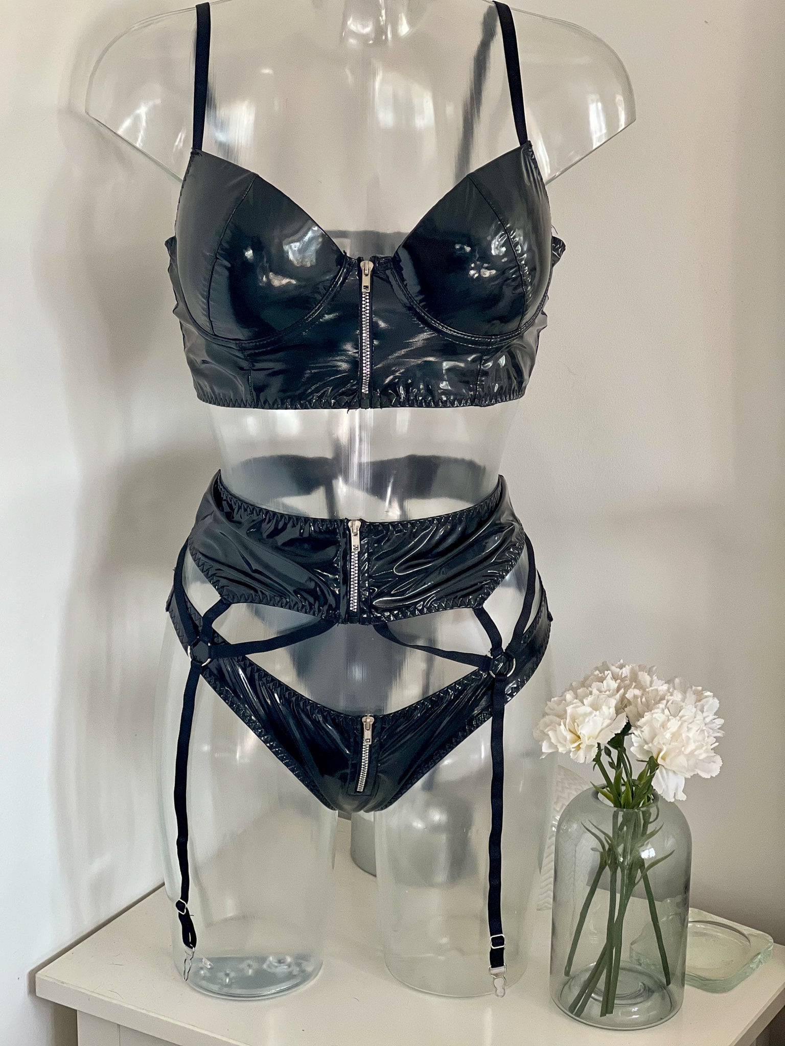 Pvc bra, pant and suspender belt with zip detailing. 